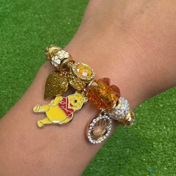 Gold and yellow Winnie the Pooh charm bracelet. - Picture 1 of 3